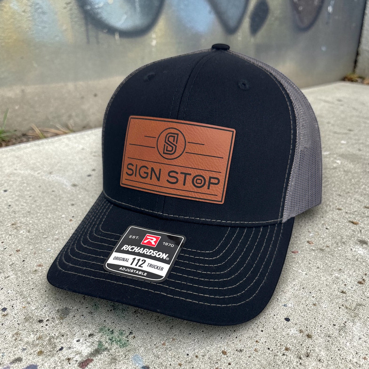 Black and charcoal Richardson 112 company hat with custom leather patch.