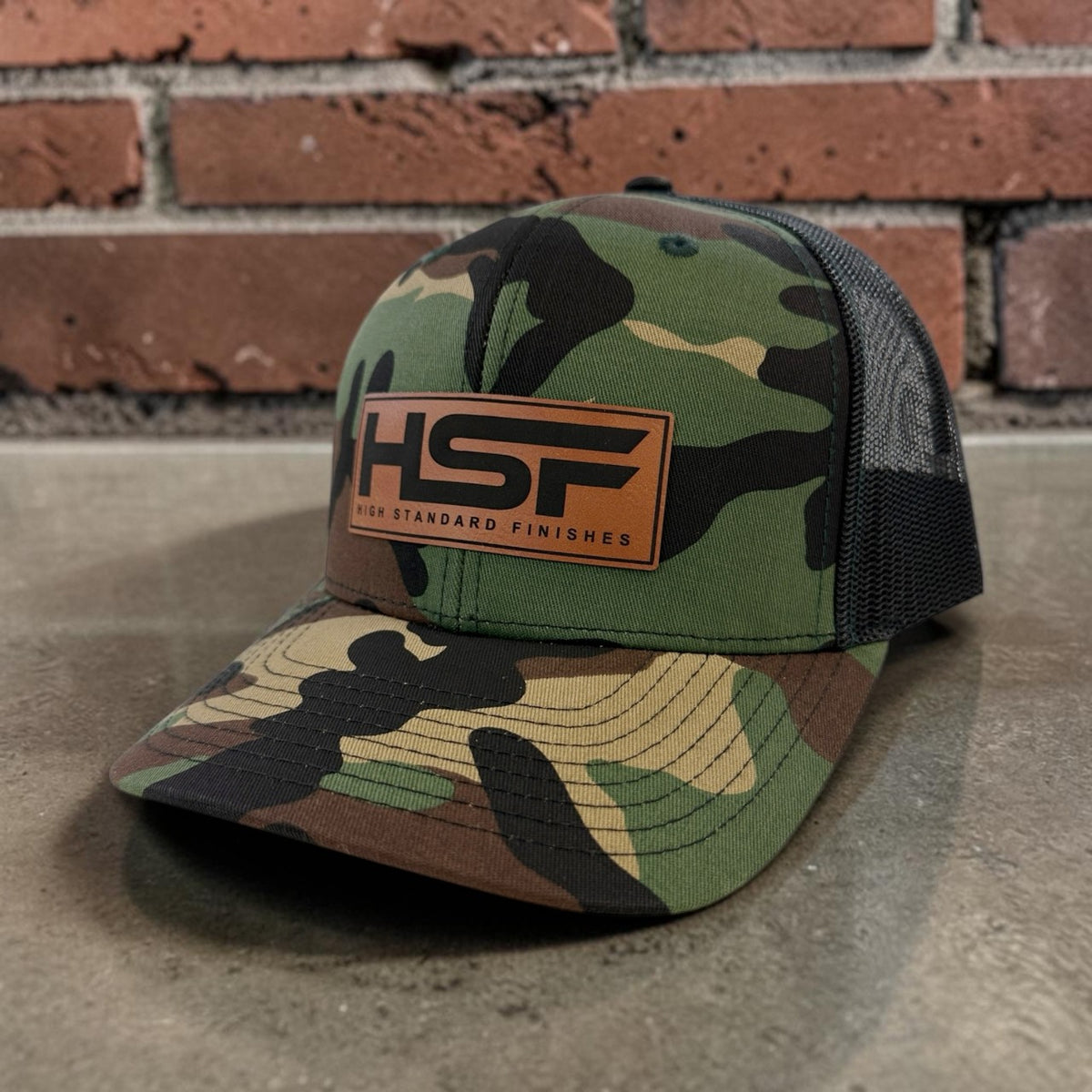 Grey and black Richardson 112 company hat with custom leather patch.
custom-leather-patch-hat-camo-black.jpg